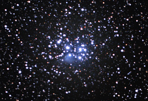The Pleiades, also known as the Seven Sisters, is an open cluster of stars located approximately 440 light-years away towards the constellation of Taurus (The Bull), making it the nearest star cluster to Earth. The cluster’s central region spans about eight light-years, with the diameter of the Pleiades as a whole estimated at 43 light-years. The Pleiades is a very prominent sight to the unaided eye during winter in the Northern Hemisphere, while in summer the cluster is best seen by observers in southern latitudes. Most of the cluster’s members are very young, hot blue stars formed within the last 100 million years. So far, about 1,000 stars have been confirmed. The hint of bluish nebulosity around the brightest stars originates from a cloud of interstellar gas and dust that the cluster is passing through at the moment. The tiny particles of dust scatter the blue light from the nearest stars more favourably than other colours, so the region appears to twinkle in blue. The cluster contains many brown dwarfs, or failed stars. These objects, though more massive than planets, do not possess enough mass to ignite nuclear fusion reactions in their cores and burst into life as bright stars. Cultures all over the world have marvelled at the Pleiades since early times, including the Maori from New Zealand, the Persians, the Indians, the Chinese, and the Maya and the Aztec in Central and South America. The Japanese call the Pleiades Subaru. Of the many ancient references to this remarkable and dazzling star assembly, among the most notable are those of the ancient Greek poets Hesiod and Homer, who included the Pleiades in his epic poems the Iliad and the Odyssey circa 750 BC. The Bible also contains three mentions of the Pleiades. The French comet hunter Charles Messier determined the position of the cluster and included it as the entry number 45 (Messier 45) in his famous catalogue from 1771.